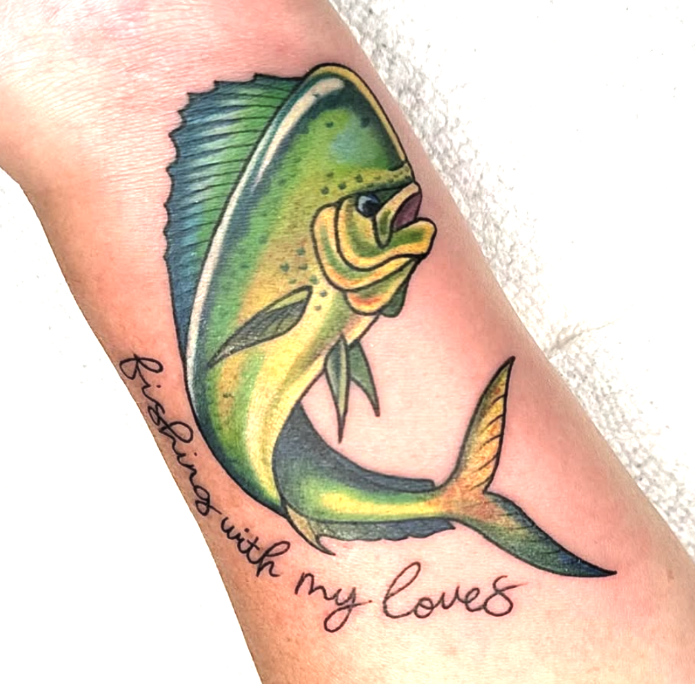 Colorful tattoo of a fish, with the words "fishing with my love" written in cursive below it.