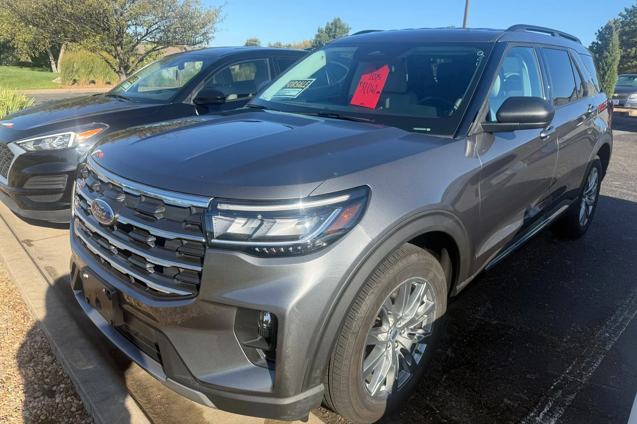 A gray 2025 Ford Explorer sits in the Quantum Credit Union parking lot.