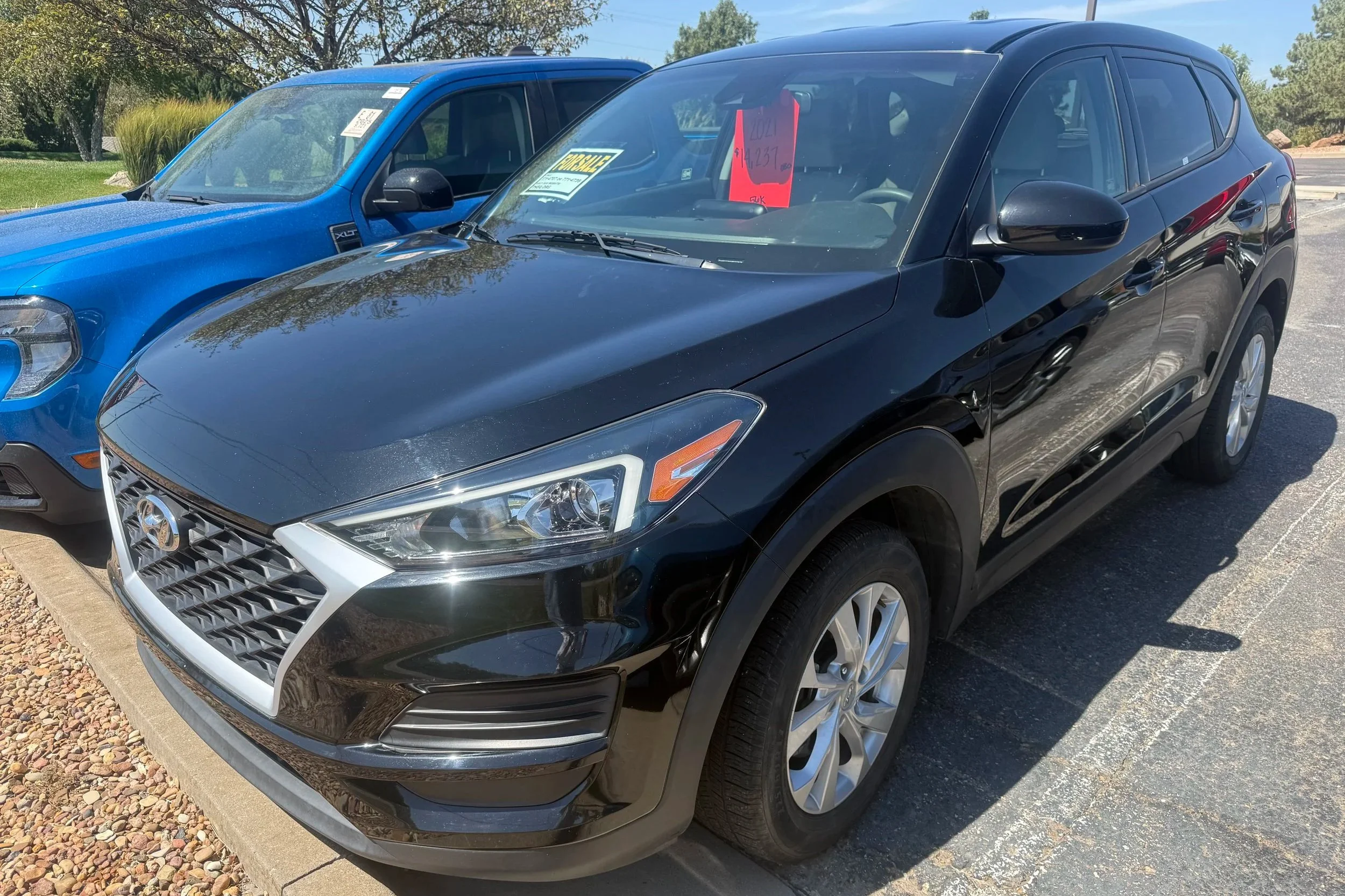 A black 2021 Hyundai Tucson sits in the Quantum Credit Union parking lot.