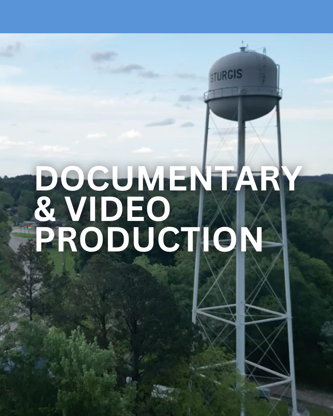 A water tower with the word 'STURGIS' on it, set against a cloudy sky and surrounding green trees, overlaid with the text 'Documentary & Video Production'.