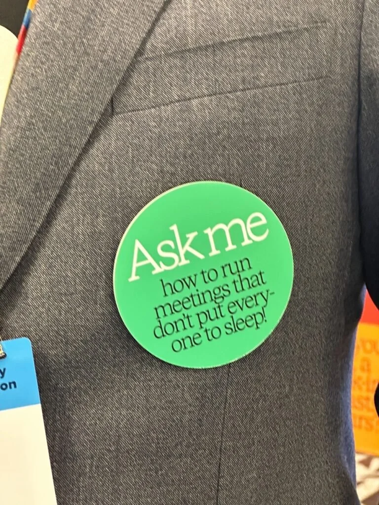 Green button badge that says 'Ask me how to run meetings that don't put everyone to sleep!'