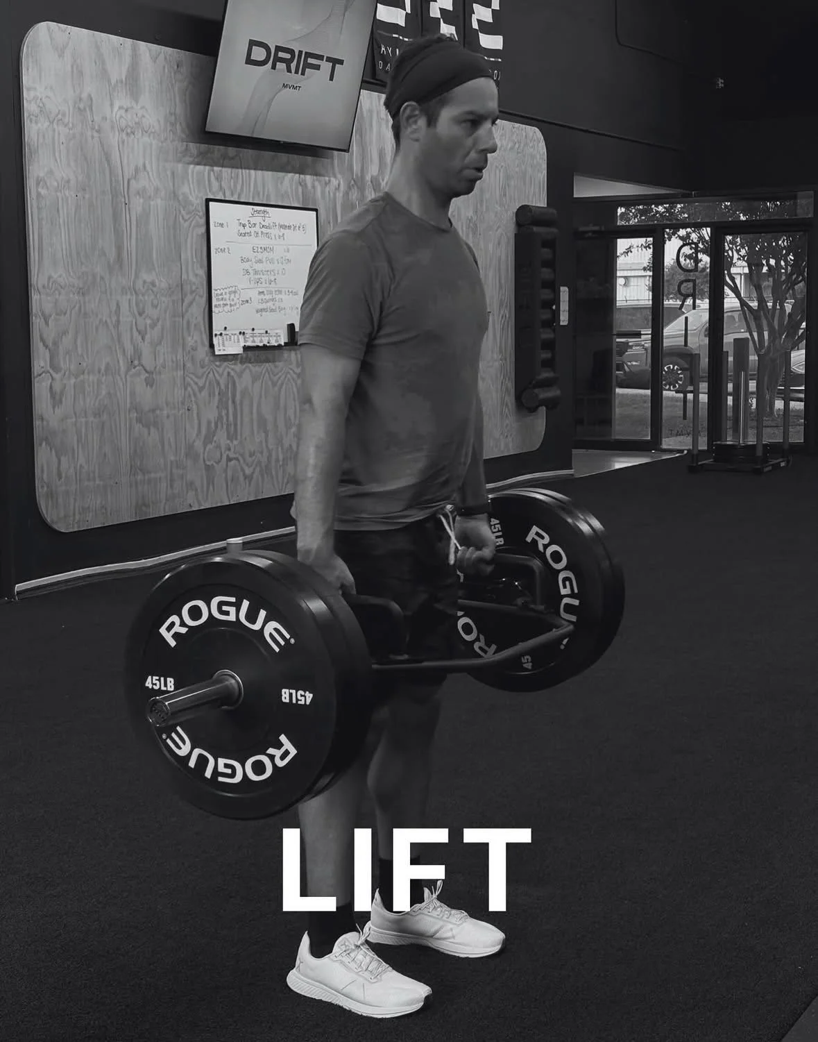 A man holding a barbell with weight plates inside a gym, with the word 'LIFT' overlaid at the bottom of the image.