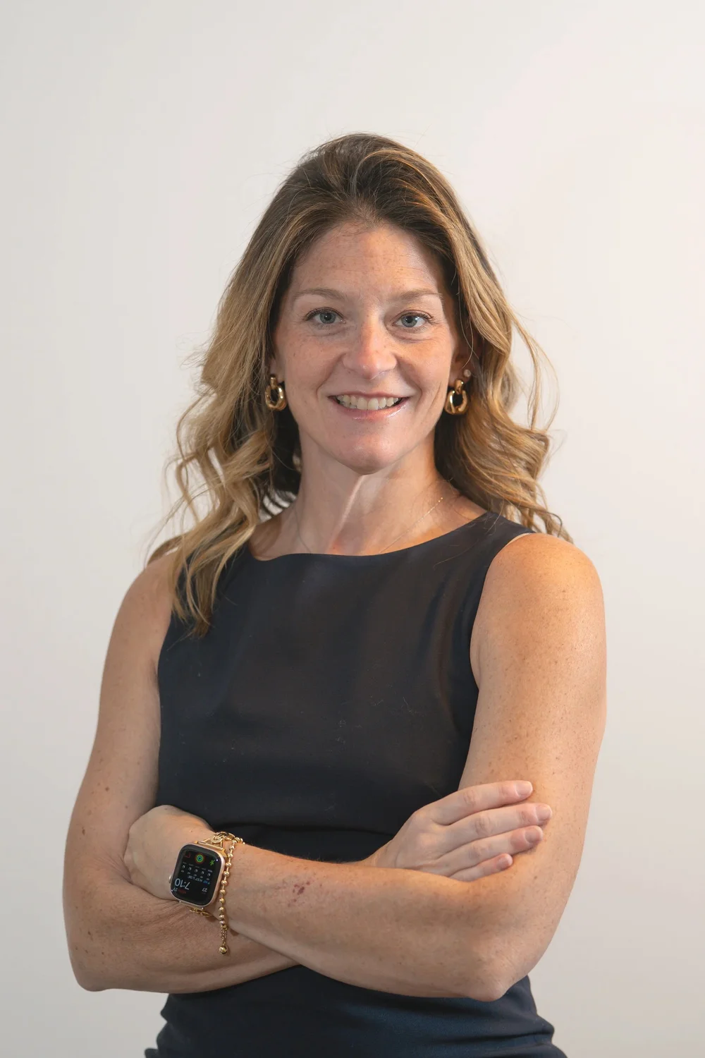 Dr. Lindsay Maggio smiling with arms crossed