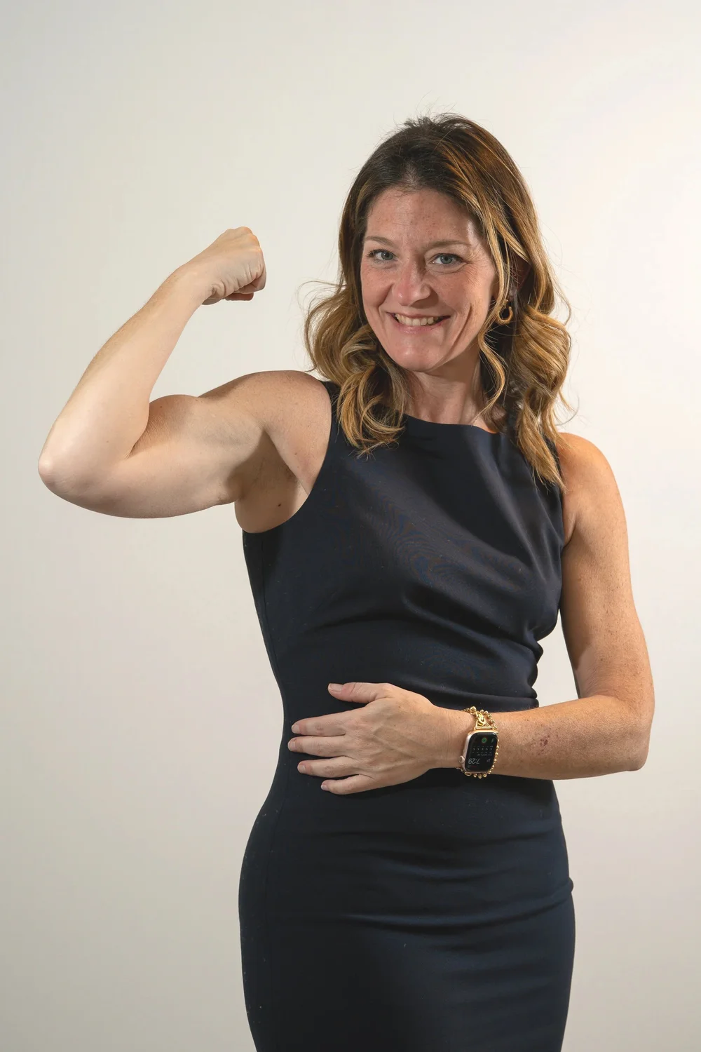 Dr. Lindsay Maggio flexing her arm and smiling
