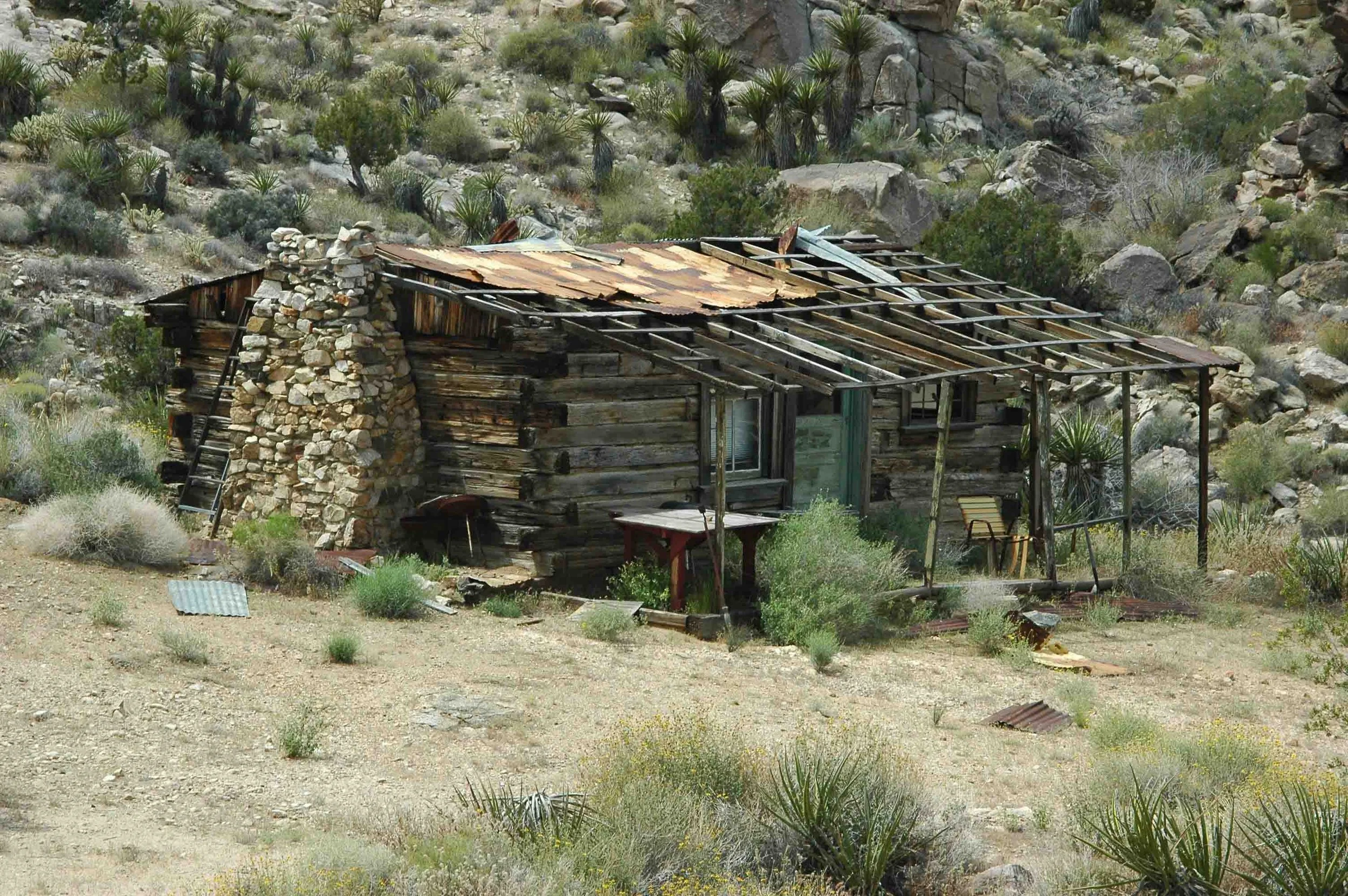 Abandoned miner's cabin in the Old Woman Mountains made of railroad ties.  This cabin still has glass in the windows, but is slowly weathering away.