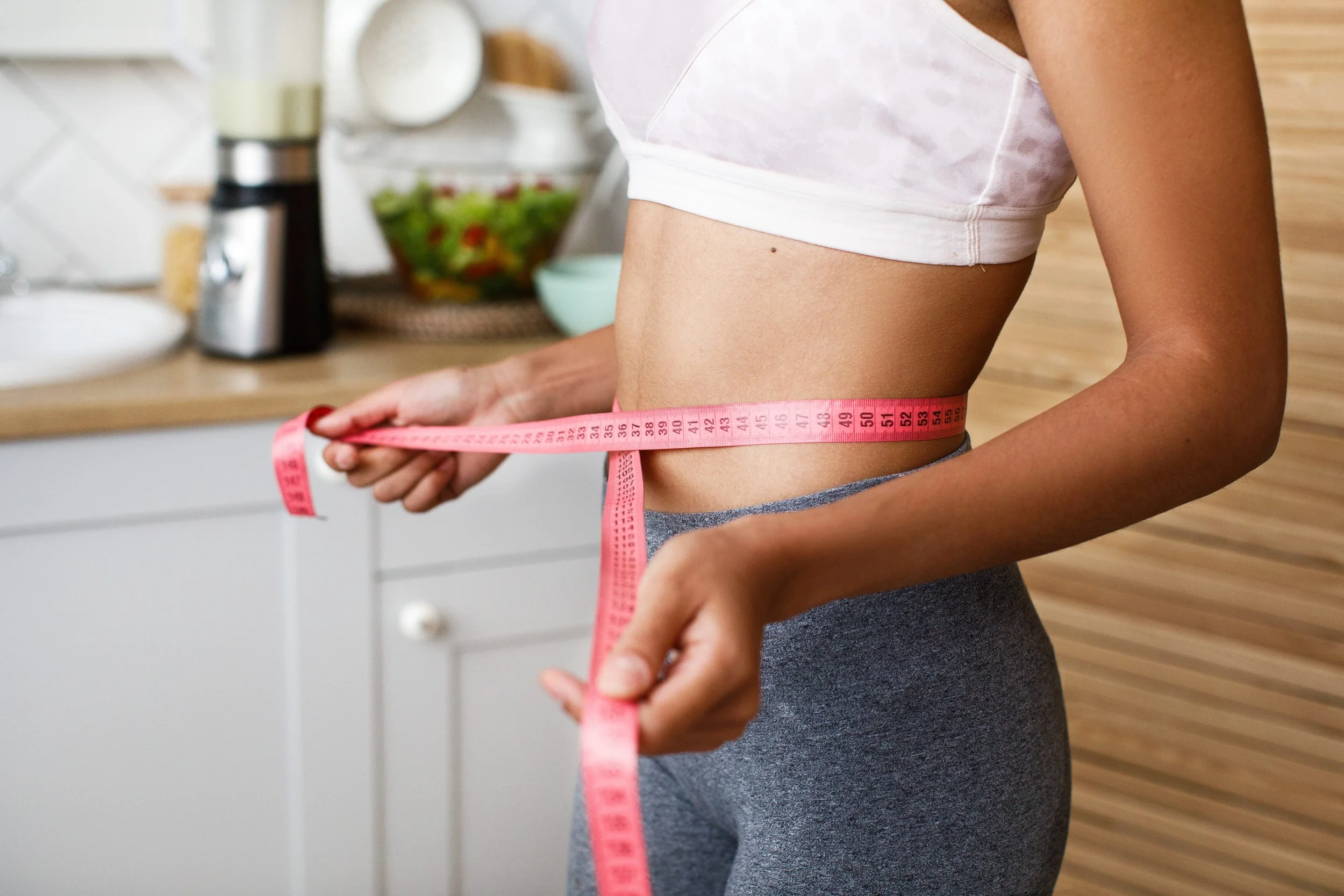 african-woman-is-measuring-her-waist-with-centimeter (1) (1).jpg