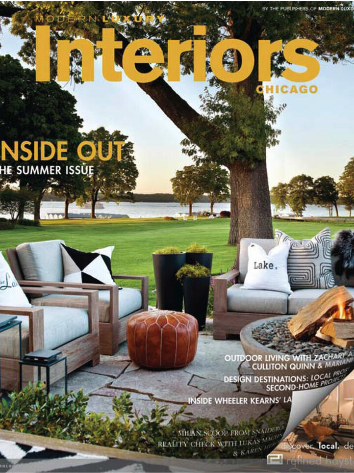 Cover of Interiors Chicago magazine featuring an outdoor patio with chairs, a fire pit, a lake view, and trees.