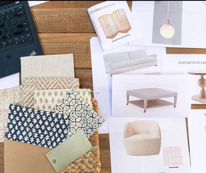 Interior design materials and swatches, with furniture and decor ideas on paper, and a keyboard in the upper left corner.