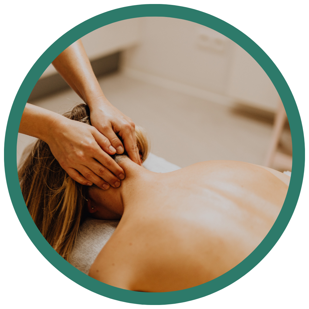 Woman receiving a massage on her shoulders and neck in a spa or clinic setting.