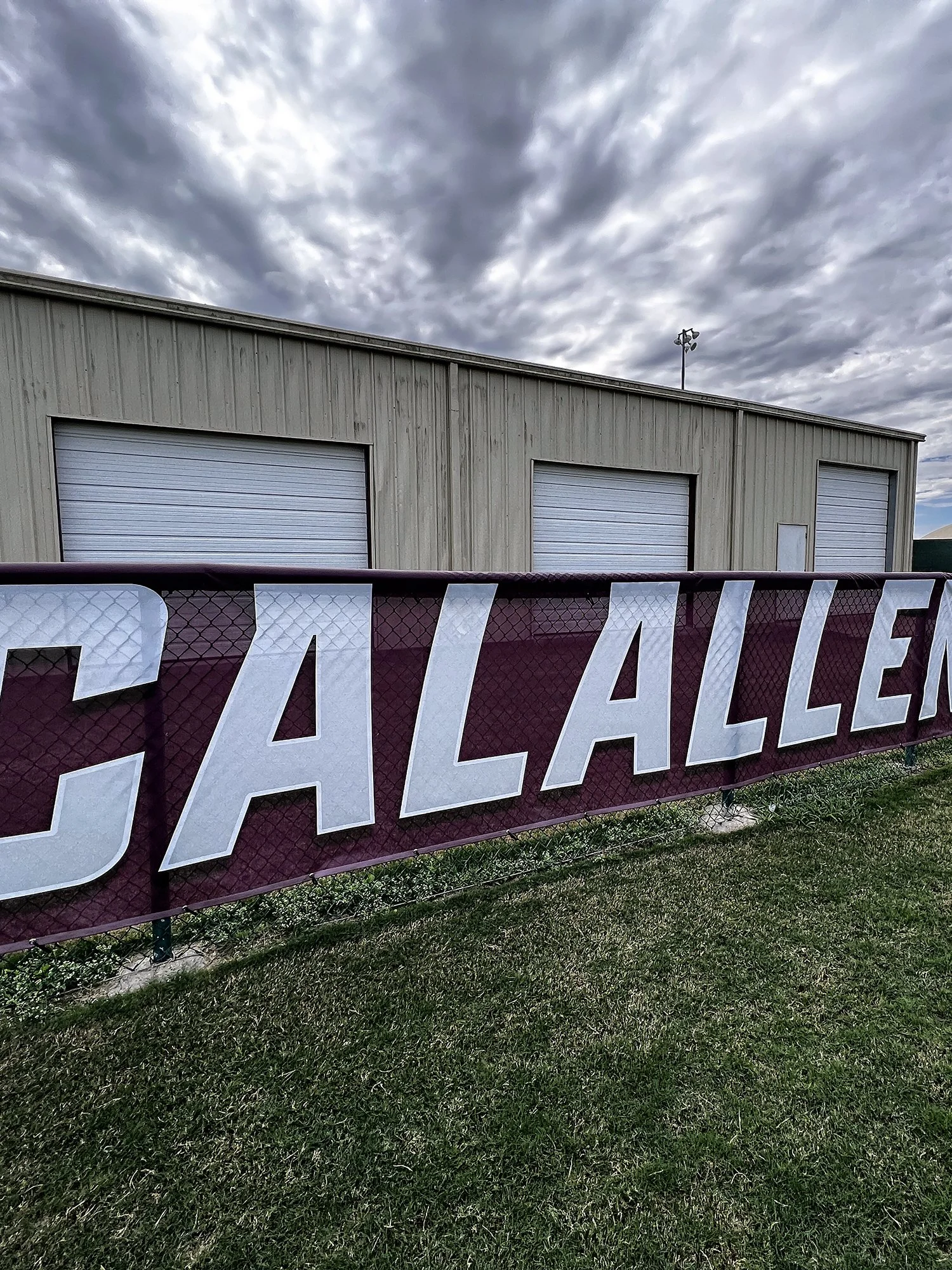 Custom fence mesh banner for Calallen High School Baseball in Corpus Christi, Texas, installed along the outfield fence for team and facility branding.