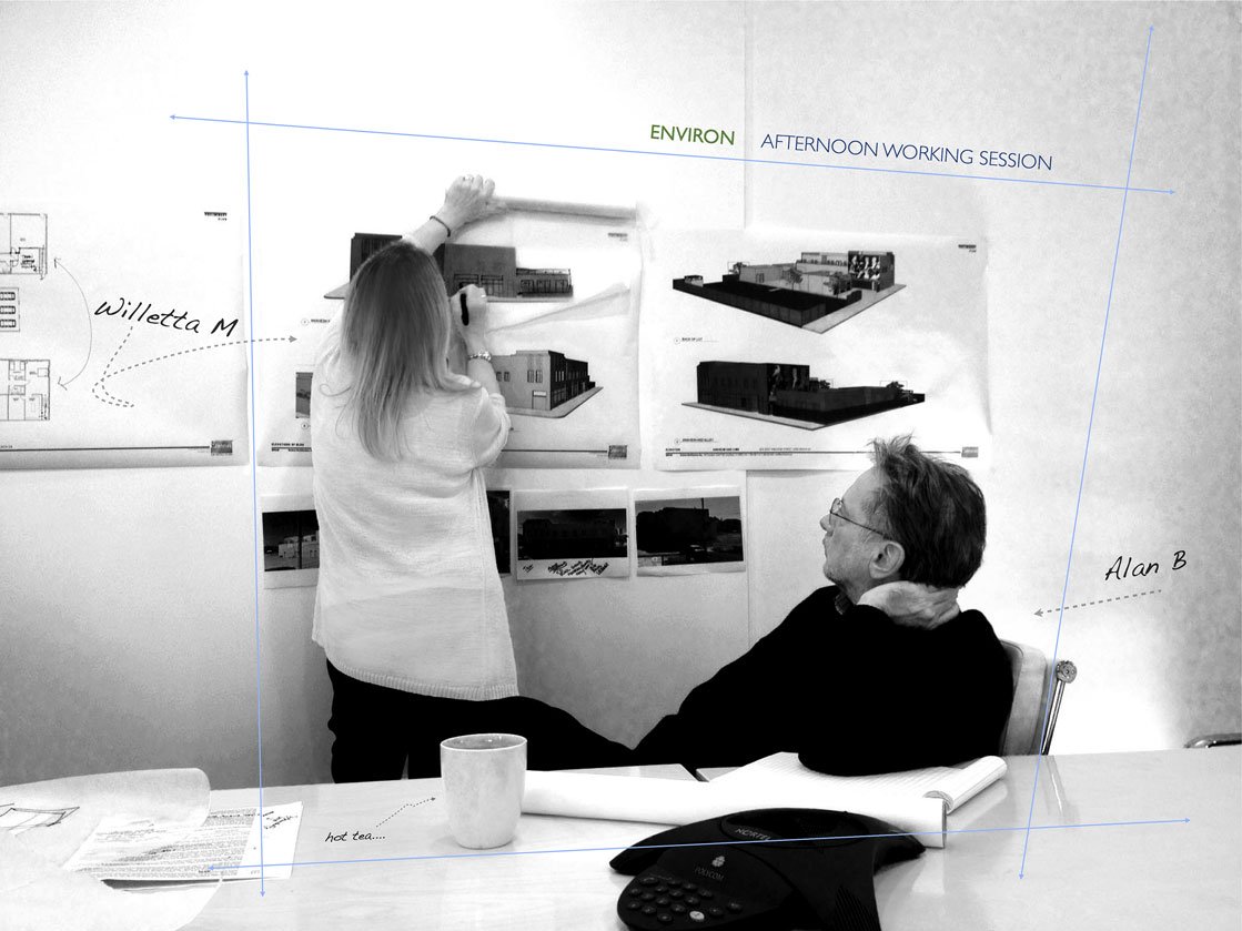 Willetta M and Alan B in a working session with renderings on the wall