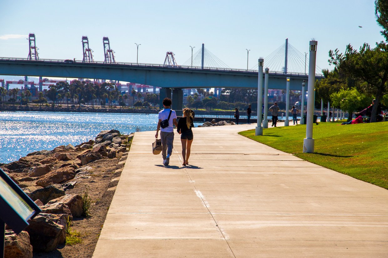 Couple walking on path near water