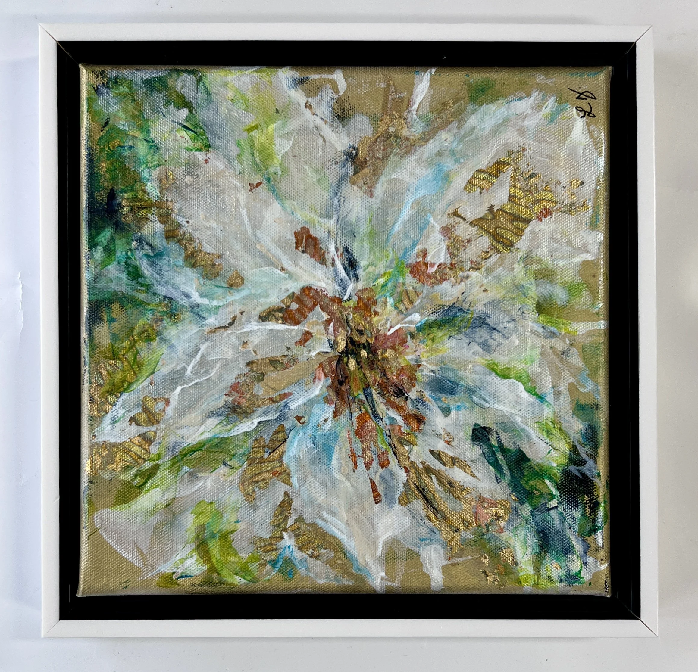 Textured mixed-media floral in blues, greens, and whites with metallic notes, framed in a white gallery frame.