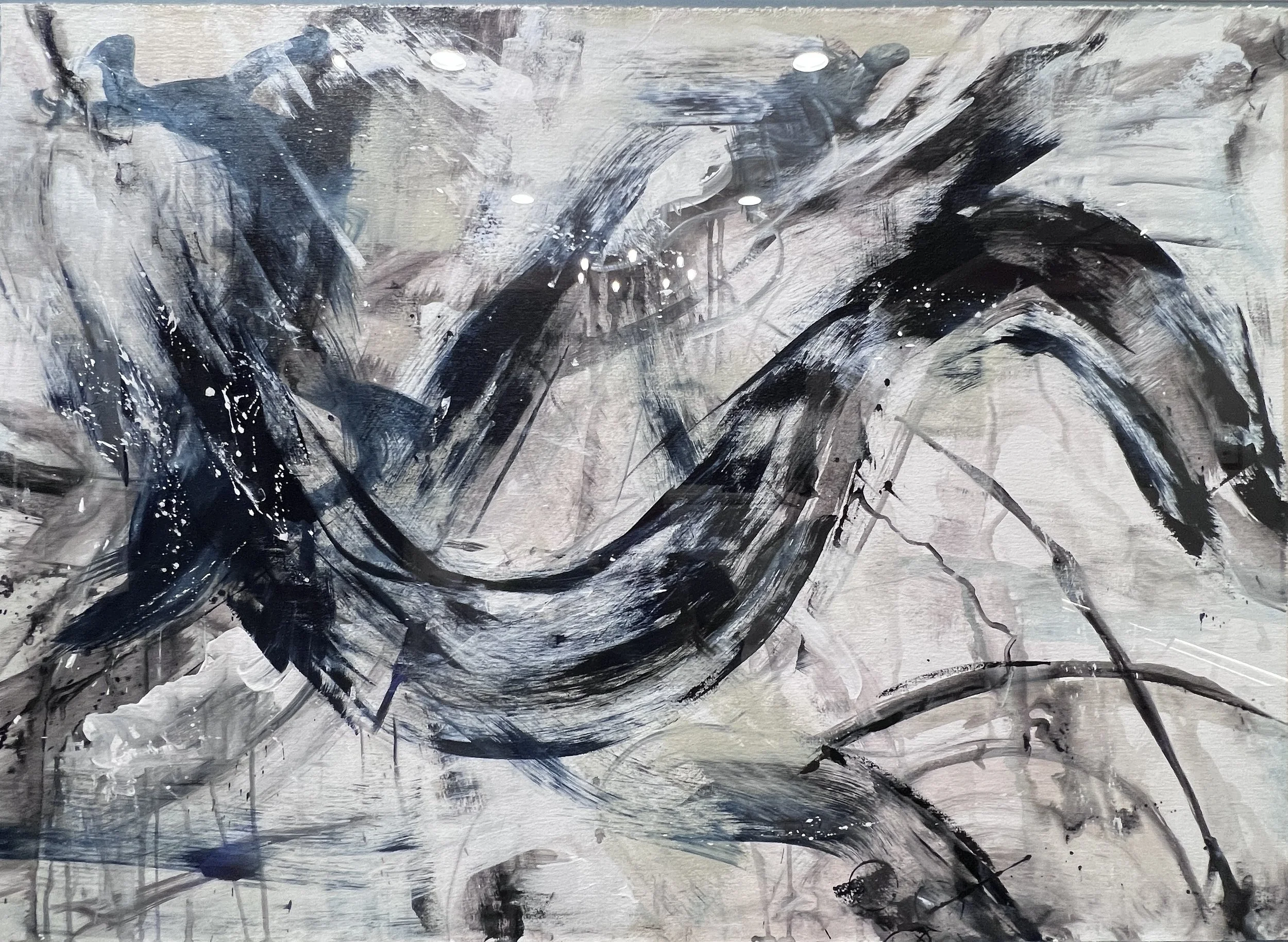 Abstract acrylic painting with bold navy and black sweeping strokes on raw canvas with soft gray and white accents.