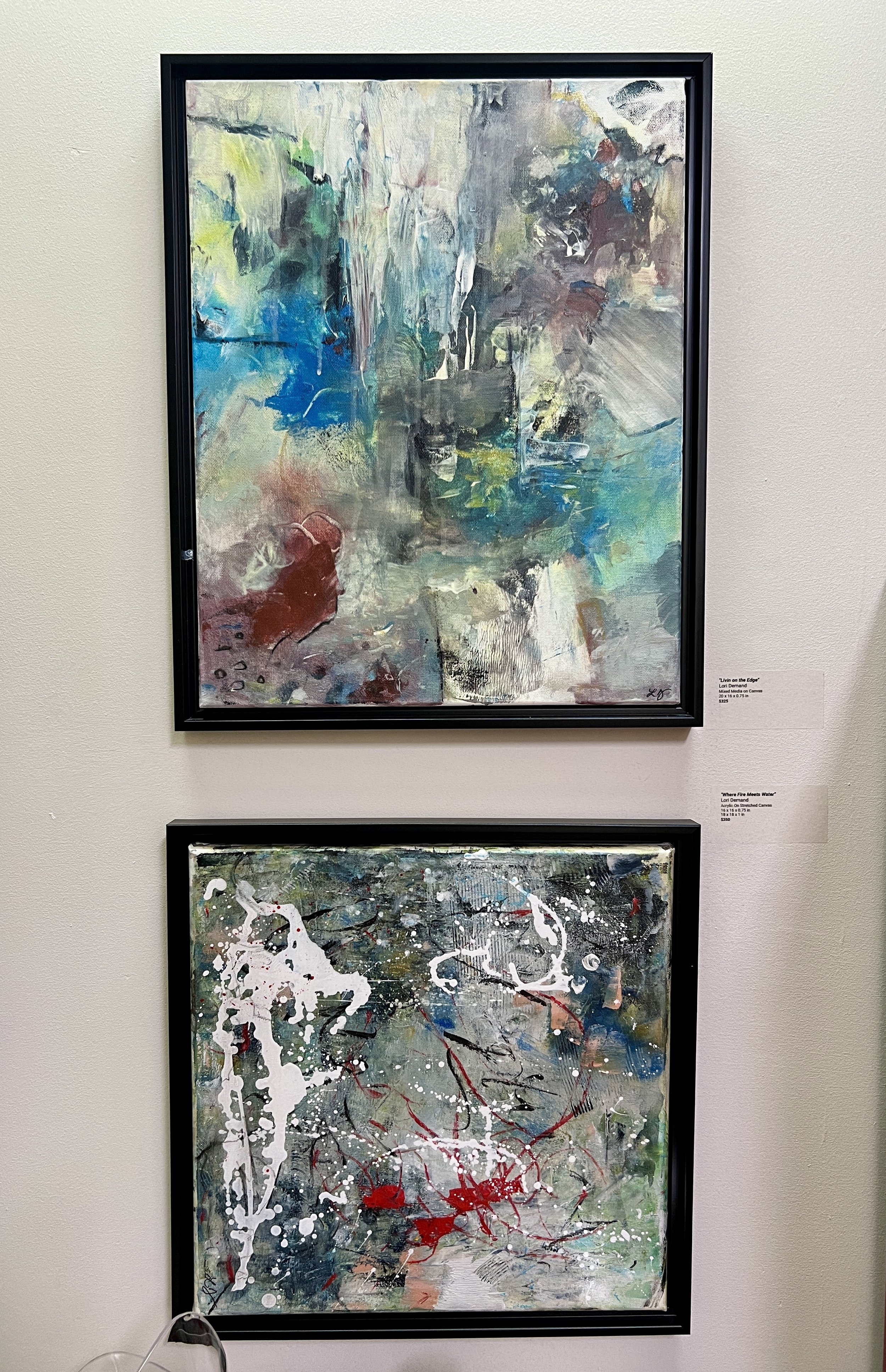 Abstract painting with blue, gray, white, and red tones, featuring layered textures and bold, blended brushstrokes.