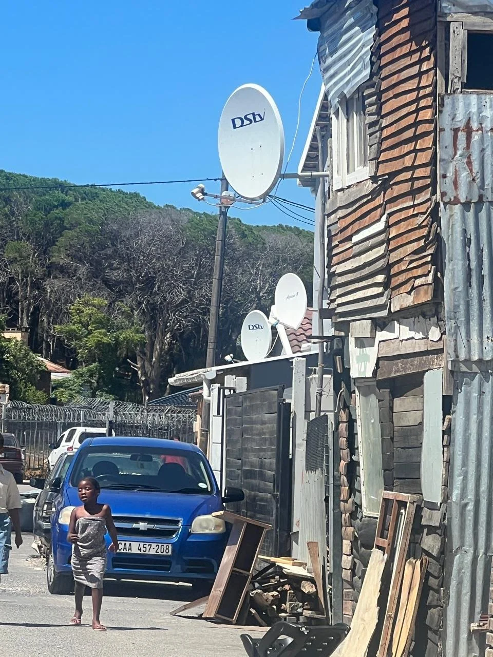 Mädchen spaziert durch das Township von Imizamo Yethu