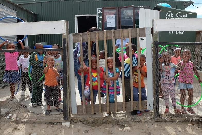 Kinder smilen auf dem Pausenhof vom Kindergarten von Ark Angels.