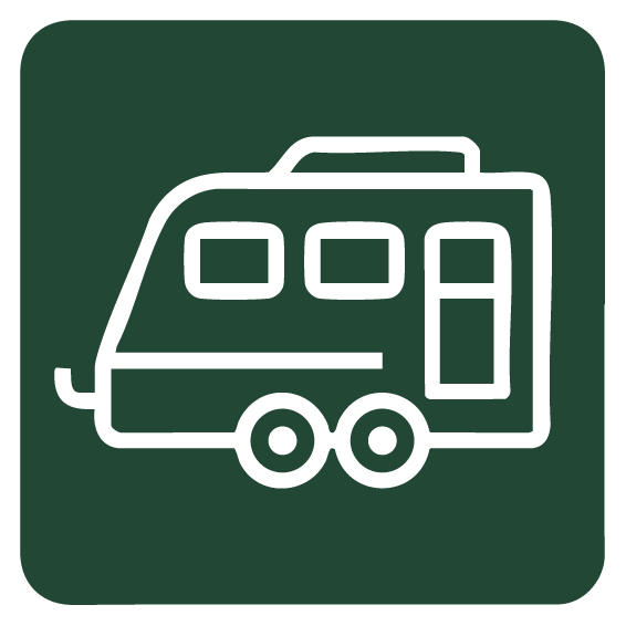 Icon of a camper van with two wheels on a green background.