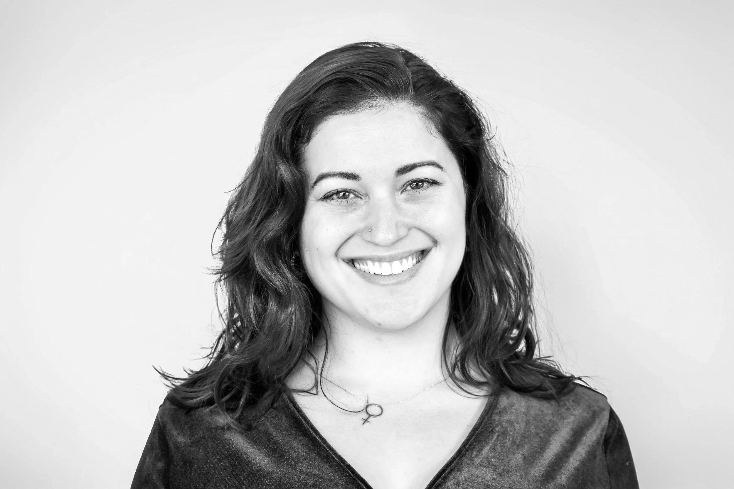 Black and white photo of a woman with long hair smiling