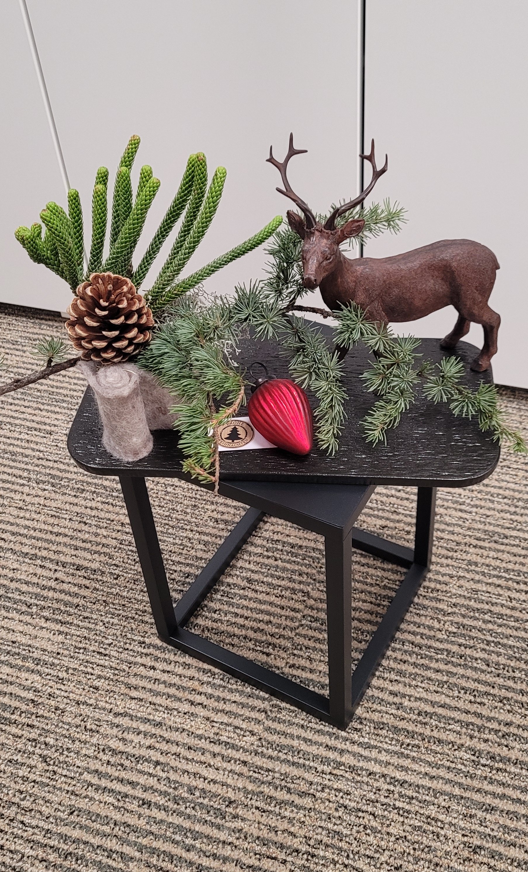 Hirsch dekoriert mit verschiedenen Naturzweigen auf Keramiktablett