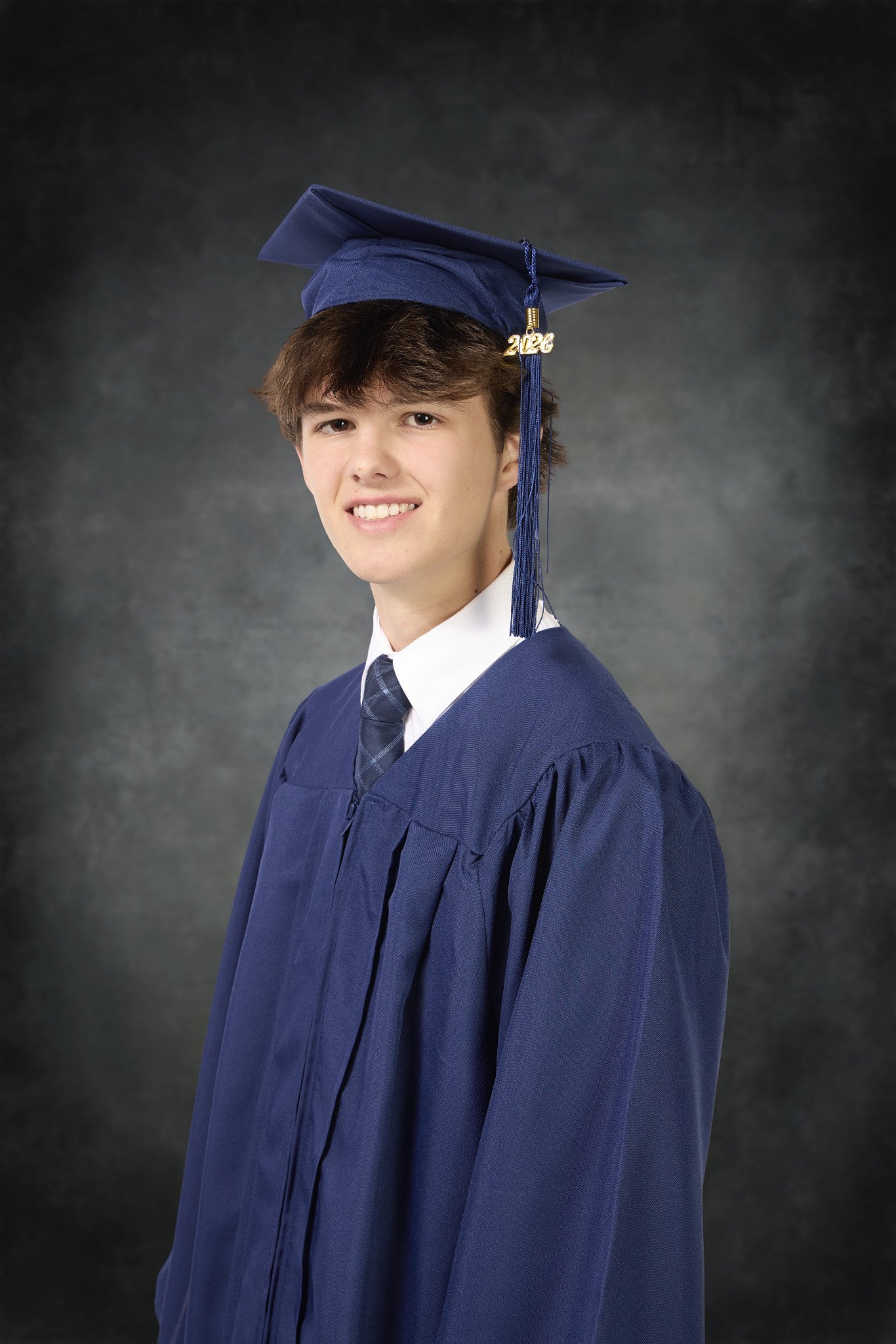 Yeich portrait- graduate 2026 cap and gown in the studio grey background