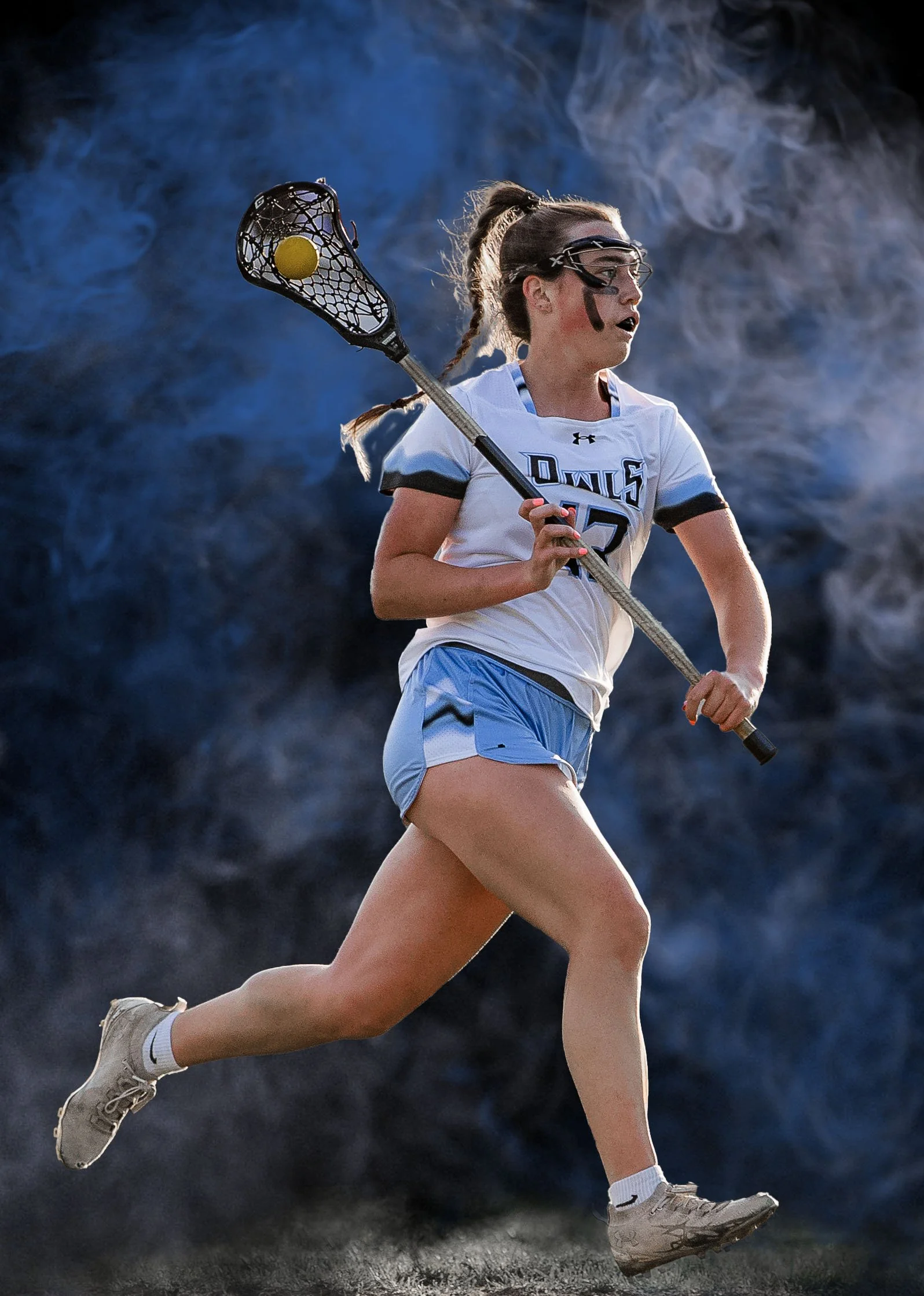Sports Action A female lacrosse player in motion on the field, wearing a white sports jersey, shorts, and protective goggles, holding a lacrosse stick with a yellow ball, with a smoky or misty background.