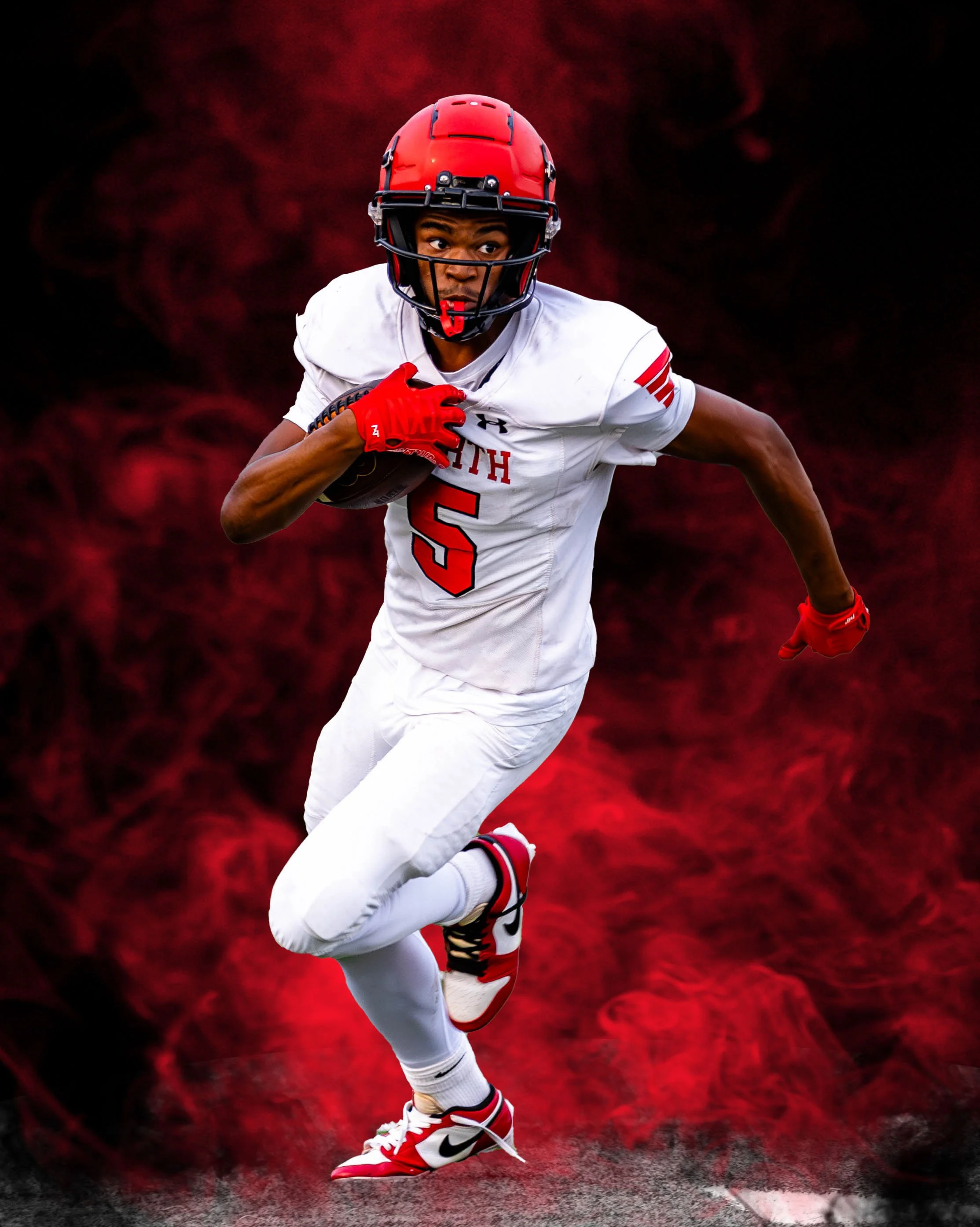 A football player running on the field, wearing a white uniform with red and black details, a red helmet, red gloves, and white cleats with red and black accents, against a dark background.