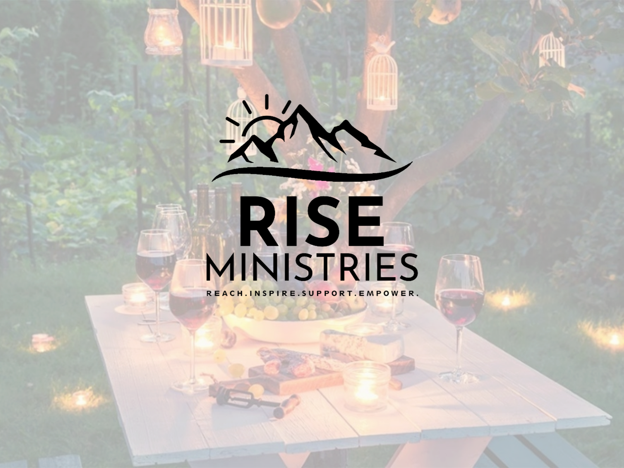 An outdoor dinner scene at sunset with a table set with wine glasses, a bowl of fruit, bread, candles, and a decorative backdrop of trees and hanging lanterns, under a sign that reads "RISE MINISTRIES" and the words "REACH. INSPIRE. SUPPORT. EMPOWER.".