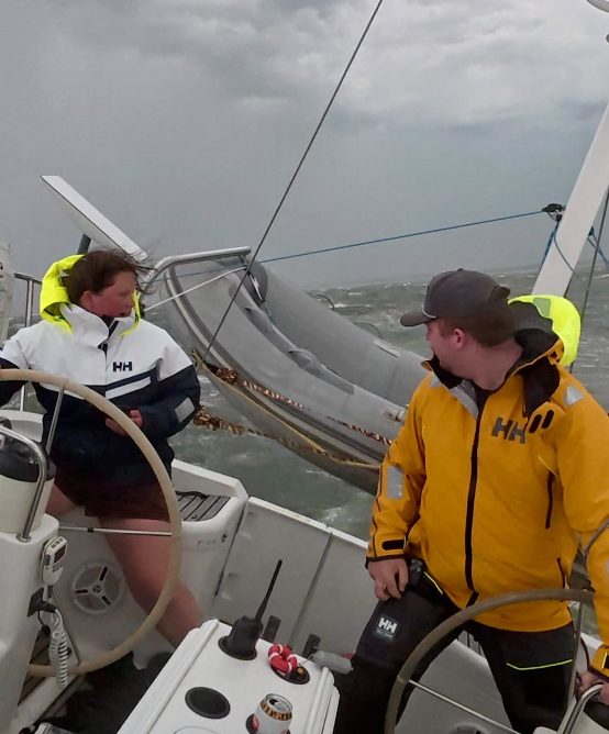 Kelsey and Nic at the helms of Fernweh in foul-weather gear