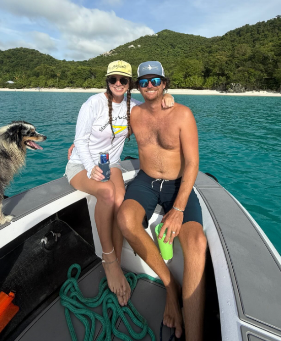 Emma and Andrew Knott with their dog in their dinghy