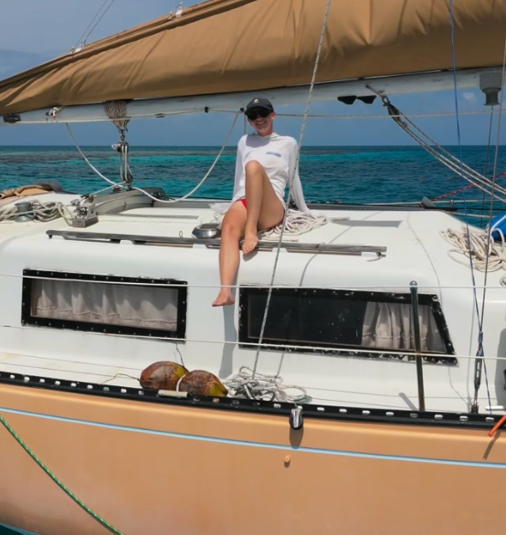 Kirsten sitting on the cabin top of S/V Nami