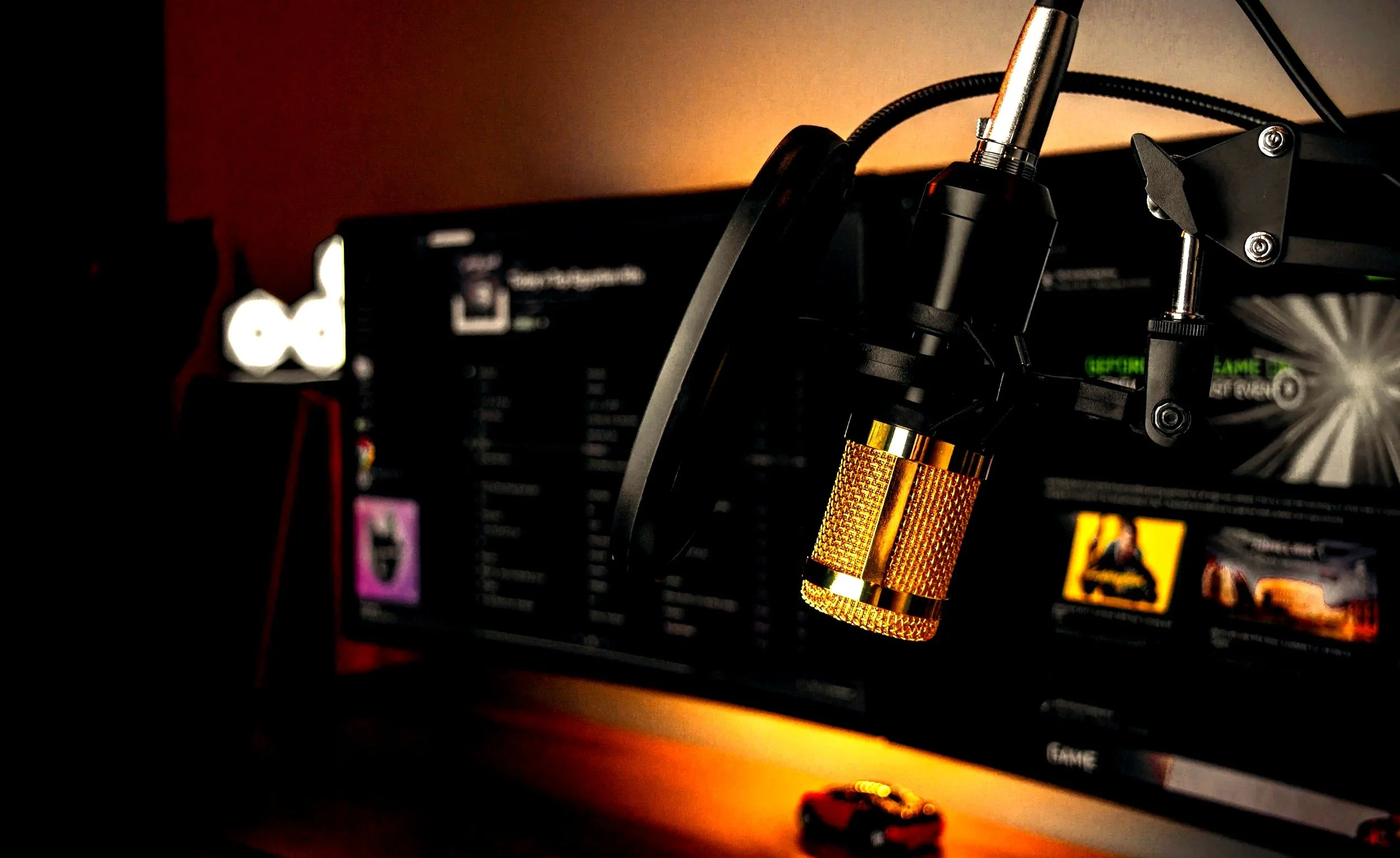 Close-up of a microphone with a screen in the background showing a gaming or streaming interface.