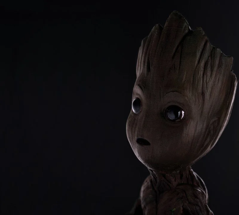 Close-up photo of Baby Groot figure with dark background