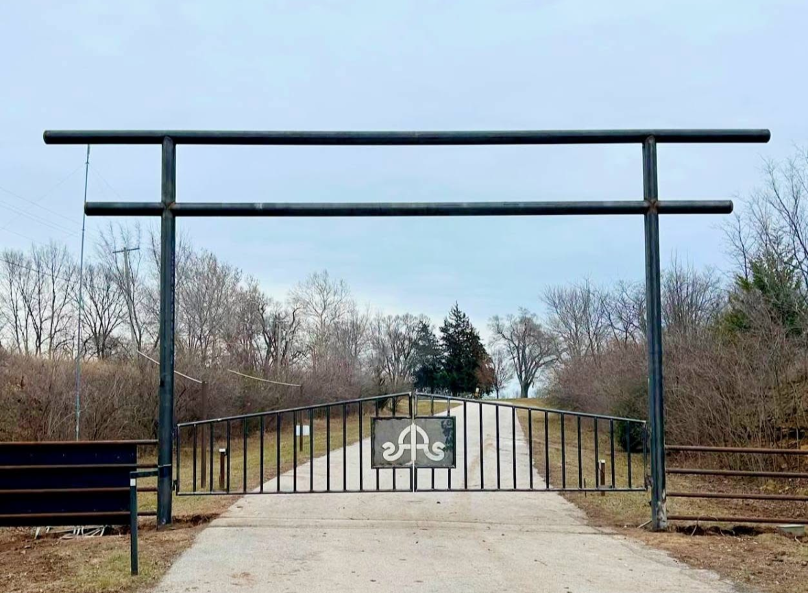A geted entrance welded together with good, quality welds with a sign cut out with a plasma cutter.
