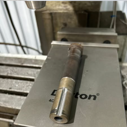 metal rod placed on a machine in a workshop 