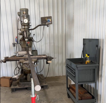 Industrial workshop with a vertical milling machine for machining bushings rods pins bolts and shafts