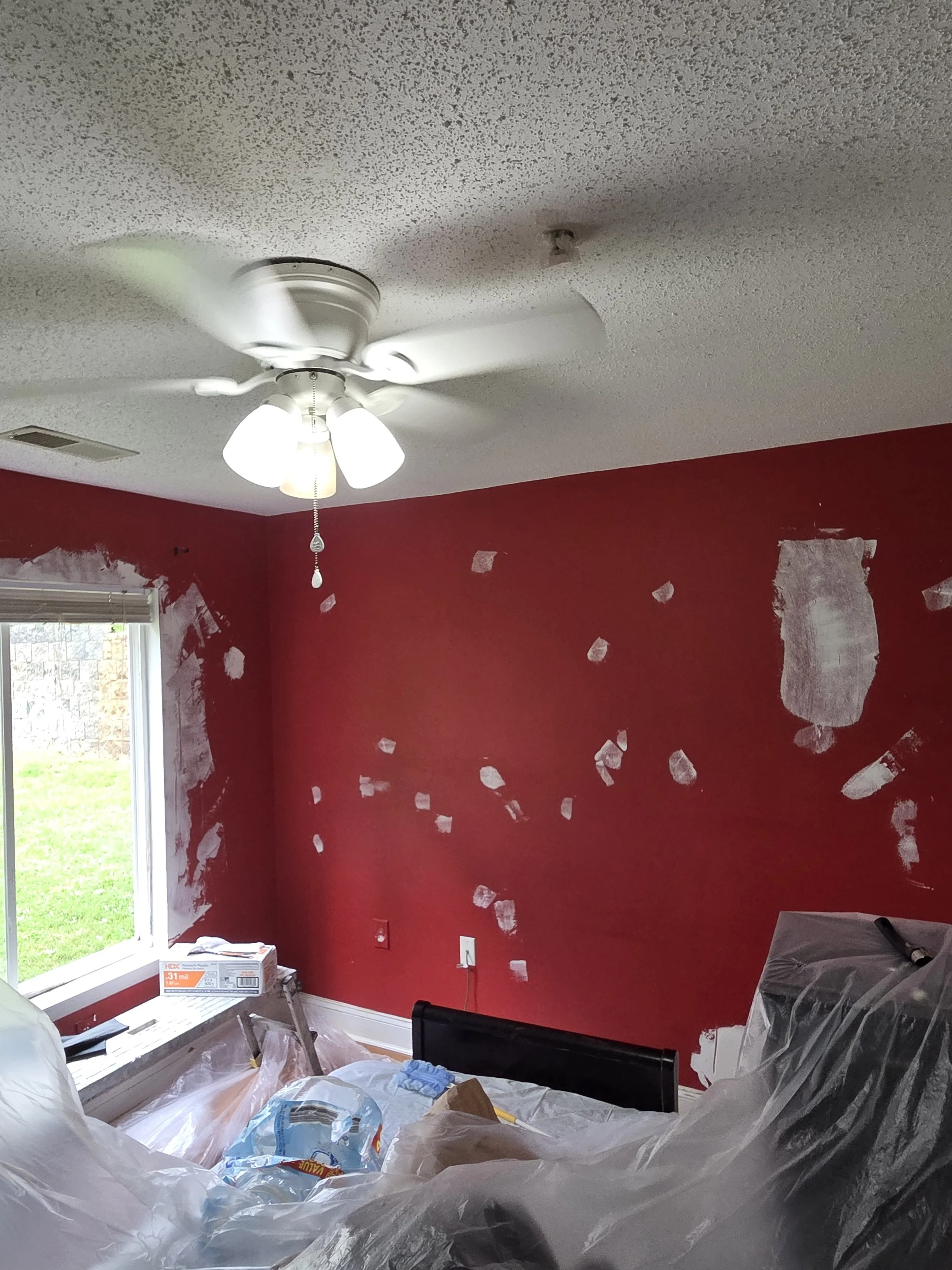 Damage repaired, photo taken before sanding. Everything in the room is covered because this amount of sanding will make a lot of dust. 