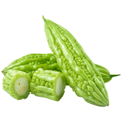 Green bitter melon with chopped pieces and one whole melon on a dark background.