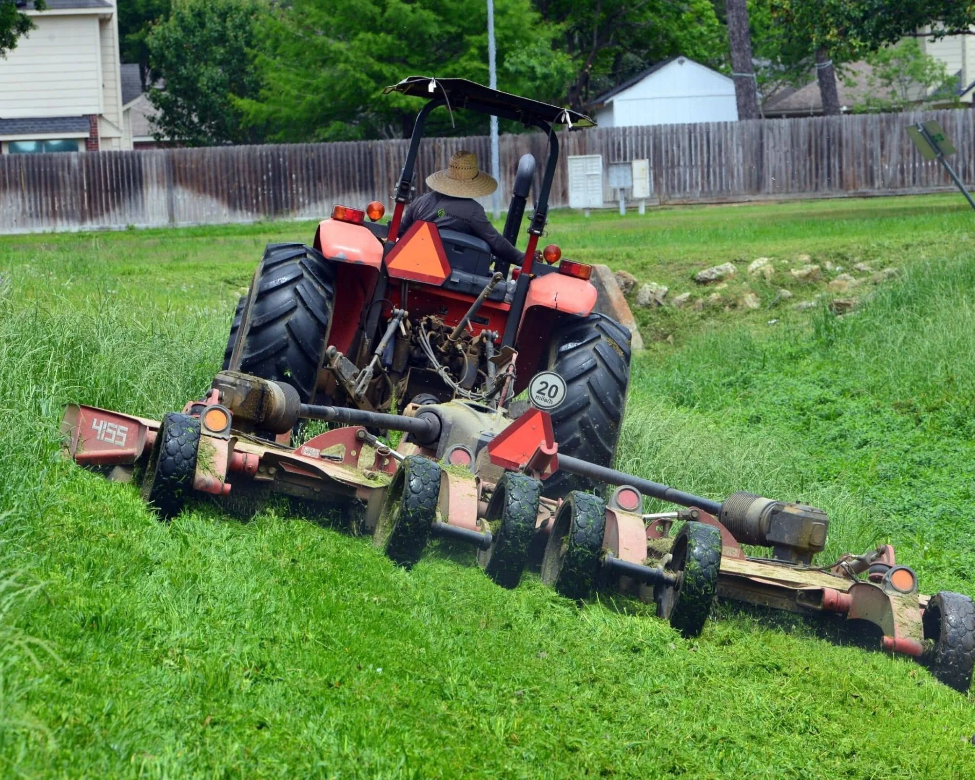 Commercial lawn care services mowing large property in Houston, TX