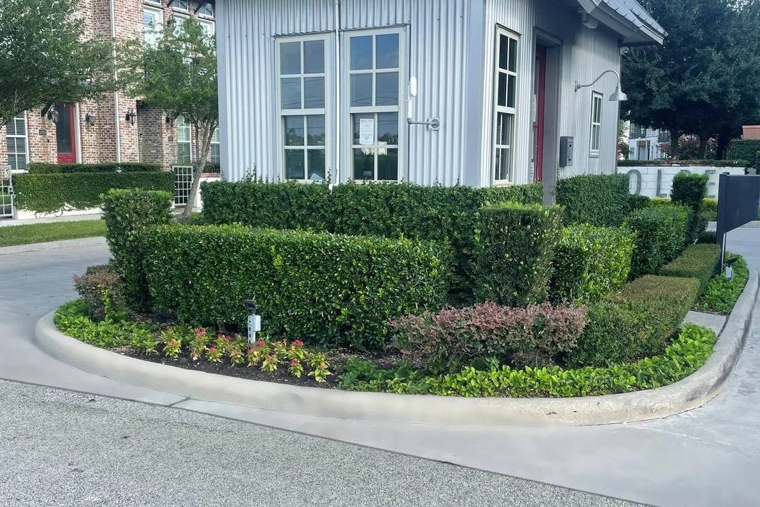 Layered hedges and colorful plantings around the Kolbe Farms entrance gatehouse. — Ethoscapes