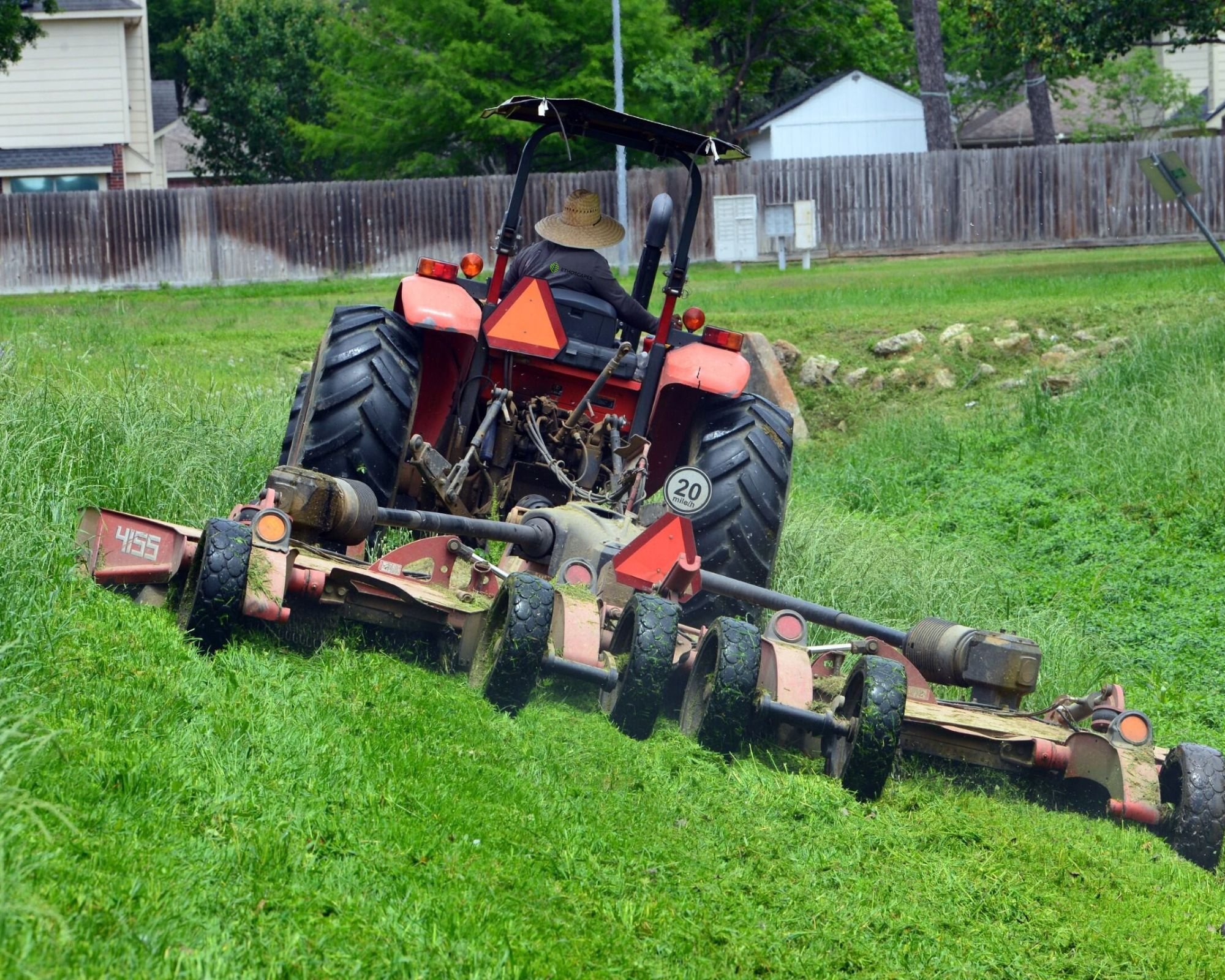 Commercial lawn care services mowing large property in Houston, TX
