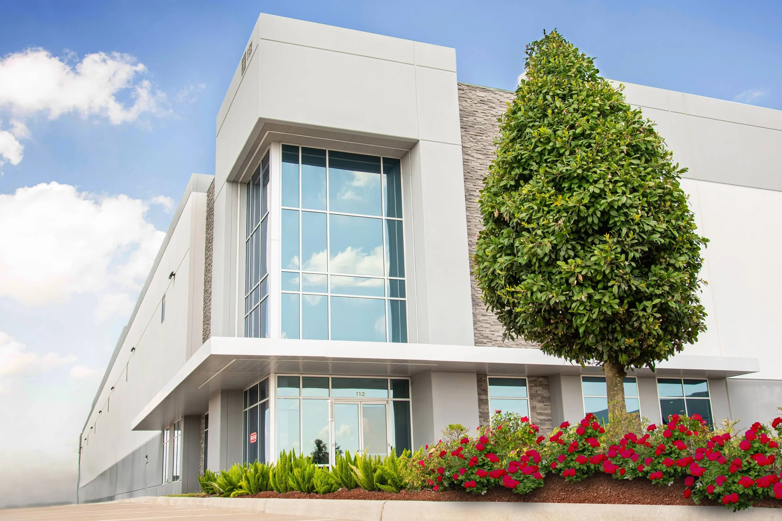 Corporate campus with manicured turf and seasonal color beds in Harris County, TX
