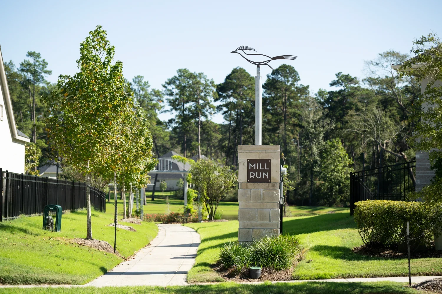 community entrance monument maintained through homeowners association landscaping in Chambers County, TX