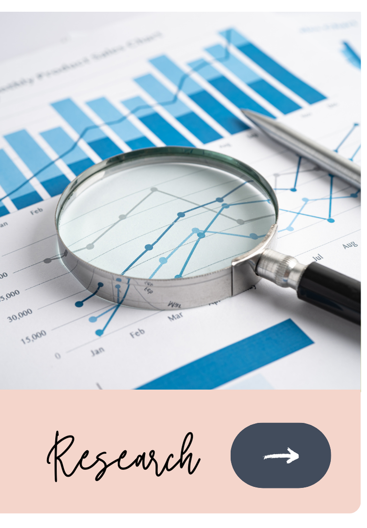 Close-up of a magnifying glass over financial graphs and charts on paper, with a pen nearby.