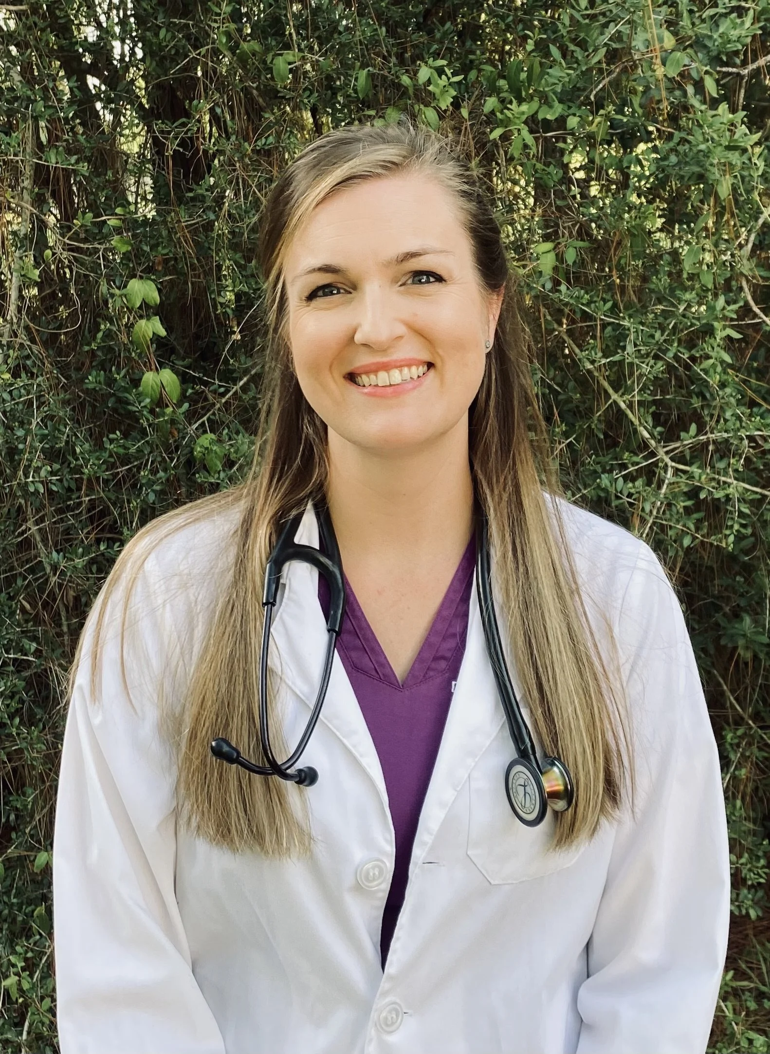 A smiling female veterinarian.