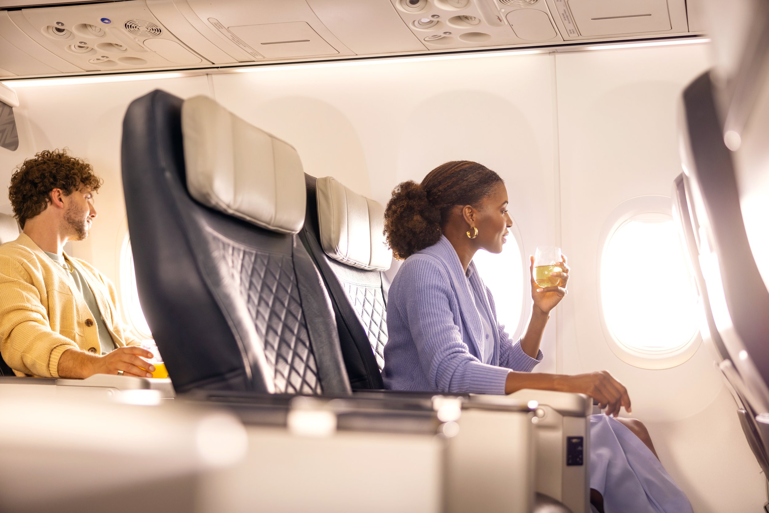 WJ-737-NH-PremiumCabin-WomanWithWhiteWine.jpg