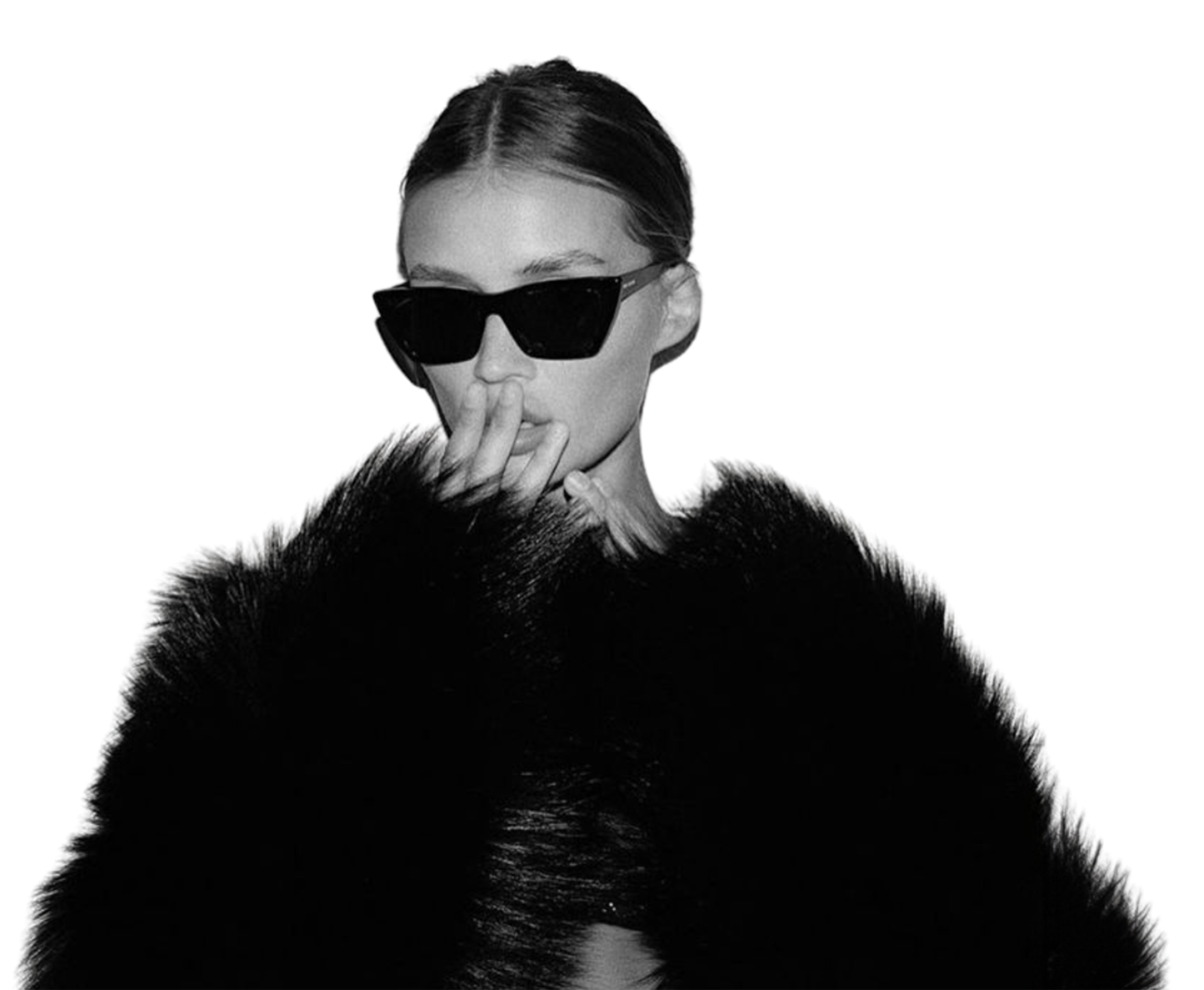 Black and white photo of a woman wearing large sunglasses and a black fur coat, with her hand near her mouth in a stylish pose.
