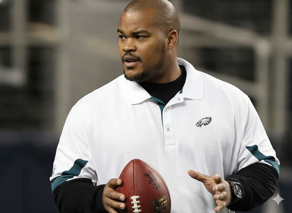 A man holding a football on a football field.