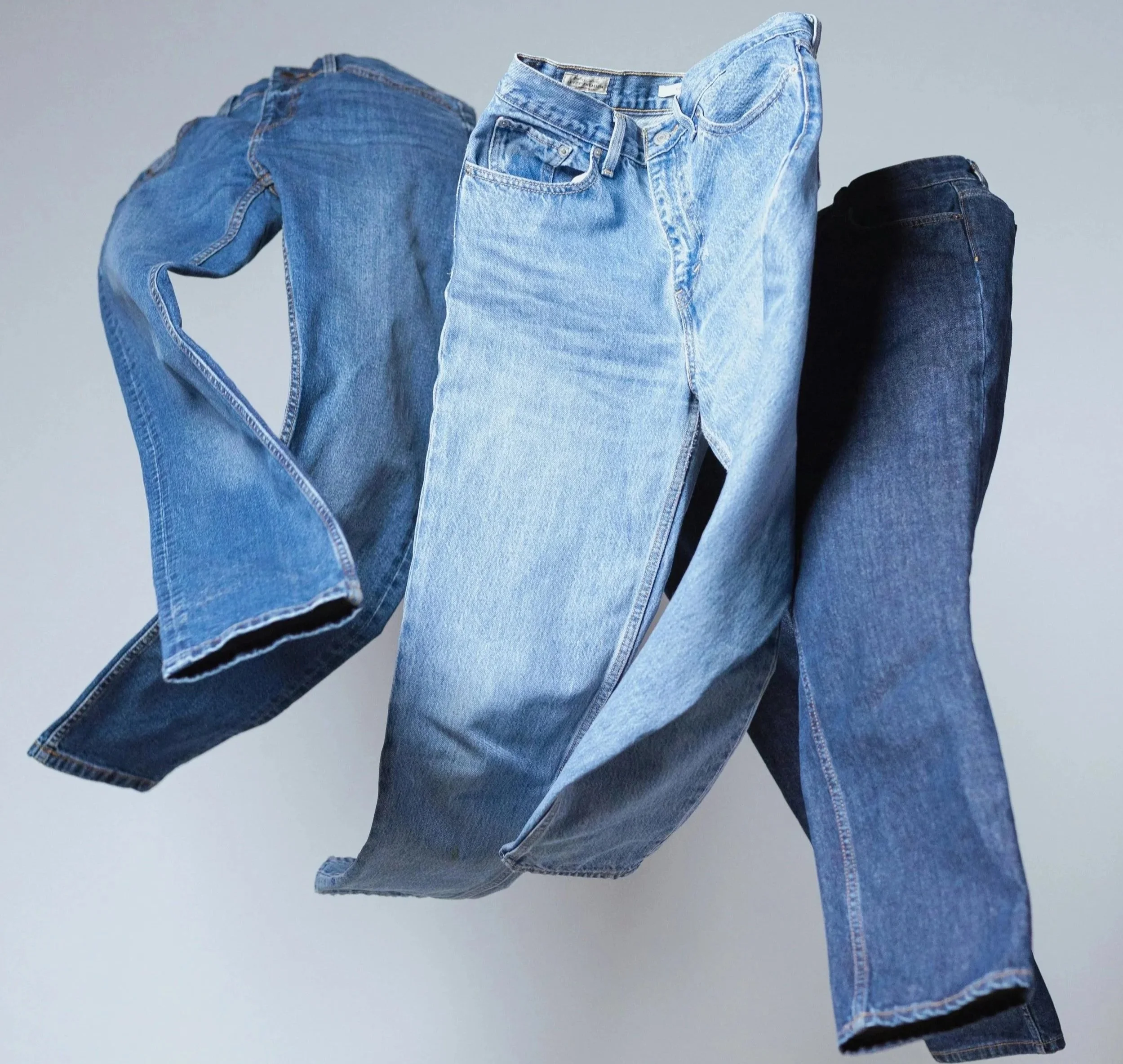 Custom-manufactured denim jeans in varied washes for a private label apparel brand.