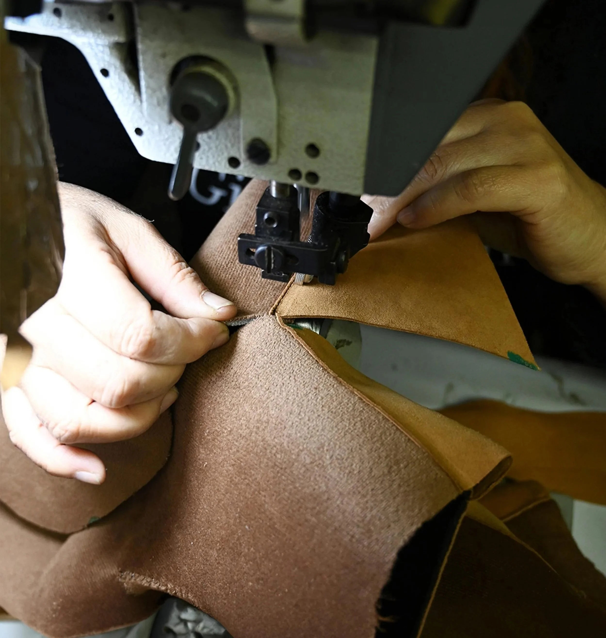 Stitching leather goods on an industrial sewing machine for a custom manufactured product line.